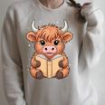 Cute Highland Cow Reading Book Raglan Sleeve Sweatshirt Heather Forest