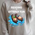 Cute Otter Reading Book Two Otter Reading Is Otterly Fun Raglan Sleeve Sweatshirt Heather Forest Cute Otter Reading Book Two Otter Reading Is Otterly Fun Raglan Sleeve Sweatshirt Heather Forest