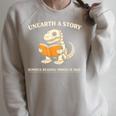 Dinosaur Books Readers Summer Reading 2026 Unearth a Story Raglan Sleeve Sweatshirt Heather Forest