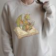 Dragon Bookworm Reading Fantasy Book Graphic Art Raglan Sleeve Sweatshirt Heather Forest Dragon Bookworm Reading Fantasy Book Graphic Art Raglan Sleeve Sweatshirt Heather Forest