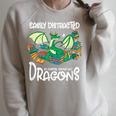 Easily Distracted By Coffee Books And Dragons Fantasy Sci-Fi Raglan Sleeve Sweatshirt Heather Forest
