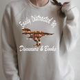 Easily Distracted By Dinosaurs And Books Outfits Men Women Raglan Sleeve Sweatshirt Heather Forest Easily Distracted By Dinosaurs And Books Outfits Men Women Raglan Sleeve Sweatshirt Heather Forest