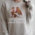 Easily Distracted By Dragon And Book Apparel Raglan Sleeve Sweatshirt Heather Forest