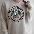 Easily Distracted By Dragons & Books Raglan Sleeve Sweatshirt Heather Forest Easily Distracted By Dragons & Books Raglan Sleeve Sweatshirt Heather Forest