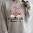 Floral Book A New Chapter Begins Retired 2026 Retirement Raglan Sleeve Sweatshirt Heather Forest Floral Book A New Chapter Begins Retired 2026 Retirement Raglan Sleeve Sweatshirt Heather Forest