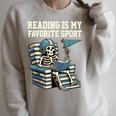 Football Skeleton Reading On Book Stack Raglan Sleeve Sweatshirt Heather Forest
