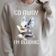 Go Away I'm Reading a Book Dragon Books And Dragons Bookish Premium Tri-Blend Raglan Sleeve Sweatshirt Heather Forest