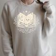 Haunted Library – Glowing Book Raglan Sleeve Sweatshirt Heather Forest