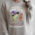 On My Way To Hoard Books And Cause Chaos Frog Raglan Sleeve Sweatshirt Heather Forest