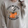 Leave Me Alone I'm Reading Skeleton Reading Book Bookish Raglan Sleeve Sweatshirt Heather Forest