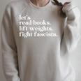 Let's Read Books Lift Weights Fight Fascists Raglan Sleeve Sweatshirt Heather Forest