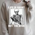 Life Is Short Buy The Book Skeleton Reading Book Raglan Sleeve Sweatshirt Heather Forest Life Is Short Buy The Book Skeleton Reading Book Raglan Sleeve Sweatshirt Heather Forest