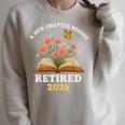 A New Chapter Begins Retired 2026 Floral Book Butterfly Tee Raglan Sleeve Sweatshirt Heather Forest A New Chapter Begins Retired 2026 Floral Book Butterfly Tee Raglan Sleeve Sweatshirt Heather Forest