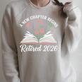 New Chapter Begins Retired 2026 Floral Book Retirement Women Raglan Sleeve Sweatshirt Heather Forest