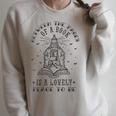 BETWEEN THE PAGES OF A BOOK IS A LOVELY PLACE TO BE Meme Raglan Sleeve Sweatshirt Heather Forest