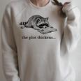 The Plot Thickens Raccoon Reading Book Bookish Raglan Sleeve Sweatshirt Heather Forest