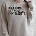 Read Books Lift Weights Fight Fascists Reading Activism Raglan Sleeve Sweatshirt Heather Forest Read Books Lift Weights Fight Fascists Reading Activism Raglan Sleeve Sweatshirt Heather Forest