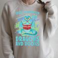 Reading Books Easily Distracted By Dragons And Books Raglan Sleeve Sweatshirt Heather Forest