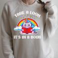 Reading Unicorn Take A Look It's In A Book Retro Rainbow Raglan Sleeve Sweatshirt Heather Forest
