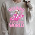 Reading Is Out Of This World Astronaut Reading Book Space Raglan Sleeve Sweatshirt Heather Forest Reading Is Out Of This World Astronaut Reading Book Space Raglan Sleeve Sweatshirt Heather Forest