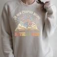 Retired 2026 A New Chapter Begins Floral Book Retirement Raglan Sleeve Sweatshirt Heather Forest