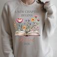 Retired 2026 Teacher Women A New Chapter Begins Floral Book Raglan Sleeve Sweatshirt Heather Forest