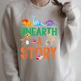 Summer Reading 2026 Dinosaurs Book Lover Unearth A Story Raglan Sleeve Sweatshirt Heather Forest Summer Reading 2026 Dinosaurs Book Lover Unearth A Story Raglan Sleeve Sweatshirt Heather Forest
