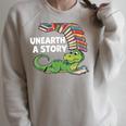 Summer Reading 2026 Unearth a Story Theme Dinosaur Book Nerd Raglan Sleeve Sweatshirt Heather Forest
