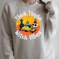 Thick Thighs Witch Vibes Spell Book And Potions Raglan Sleeve Sweatshirt Heather Forest