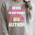 Never Underestimate An Old Woman Author Write Book Raglan Sleeve Sweatshirt Heather Forest