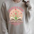 Unearth a Story 2026 Summer Reading Program Flowers Book Raglan Sleeve Sweatshirt Heather Forest