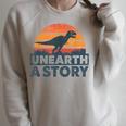 Unearth A Story Dinosaur Reader Book Lover 2026 Raglan Sleeve Sweatshirt Heather Forest
