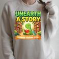 Unearth A Story Dinosaur Summer Reading 2026 Books Raglan Sleeve Sweatshirt Heather Forest