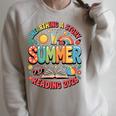 Unearth a Story Summer 2026 Summer Reading Program Book Premium Tri-Blend Raglan Sleeve Sweatshirt Heather Forest