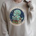 Unearth A Story Summer Reading 2026 Cute Dinosaur Reading Raglan Sleeve Sweatshirt Heather Forest Unearth A Story Summer Reading 2026 Cute Dinosaur Reading Raglan Sleeve Sweatshirt Heather Forest