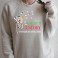 Unearth a Story Summer Reading 2026 Dandelion Books Readers Premium Tri-Blend Raglan Sleeve Sweatshirt Heather Forest