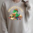 Unearth A Story Summer Reading 2026 Dinosaur Book Floral Raglan Sleeve Sweatshirt Heather Forest Unearth A Story Summer Reading 2026 Dinosaur Book Floral Raglan Sleeve Sweatshirt Heather Forest