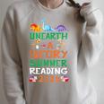 Unearth A Story Summer Reading Program 2026 Dinosaur Book Raglan Sleeve Sweatshirt Heather Forest