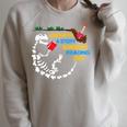 Unearth a Story T-Rex Reading a Book Summer Reading 2026 Raglan Sleeve Sweatshirt Heather Forest