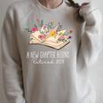 Women A New Chapter Begins Floral Book Retirement Teacher Raglan Sleeve Sweatshirt Heather Forest