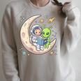 Women's Astronaut Reading Book With Alien Moon Space Astronomy Raglan Sleeve Sweatshirt Heather Forest