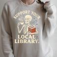 Women's Support Your Local Library Skeleton Reading Books Librarian Raglan Sleeve Sweatshirt Heather Forest