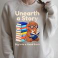 Women's Unearth A Story Reading Mammoth Prehistoric Book Librarian Raglan Sleeve Sweatshirt Heather Forest