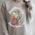 Women's Unearth a Story Summer Reading 2026 Book Lover Dino Fun Raglan Sleeve Sweatshirt Heather Forest