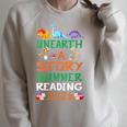 Women's Unearth A Story Summer Reading Program 2026 Dinosaur Book Raglan Sleeve Sweatshirt Heather Forest
