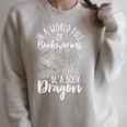 IN A WORLD FULL OF BOOKWORMS BE A Book Dragon Reader Raglan Sleeve Sweatshirt Heather Forest