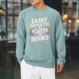 Easily Distracted By Cats And Books Raglan Sleeve Sweatshirt Cardinal