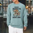 EASILY DISTRACTED BY DRAGONS & BOOKS Medieval Fantasy Reader Raglan Sleeve Sweatshirt Cardinal