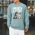 Unearth A Story Astronaut Finds Book On The Moon Raglan Sleeve Sweatshirt Cardinal