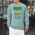 Women's Unearth a Story Summer Reading 2026 Triceratops Dino Book Raglan Sleeve Sweatshirt Cardinal Women's Unearth a Story Summer Reading 2026 Triceratops Dino Book Raglan Sleeve Sweatshirt Cardinal